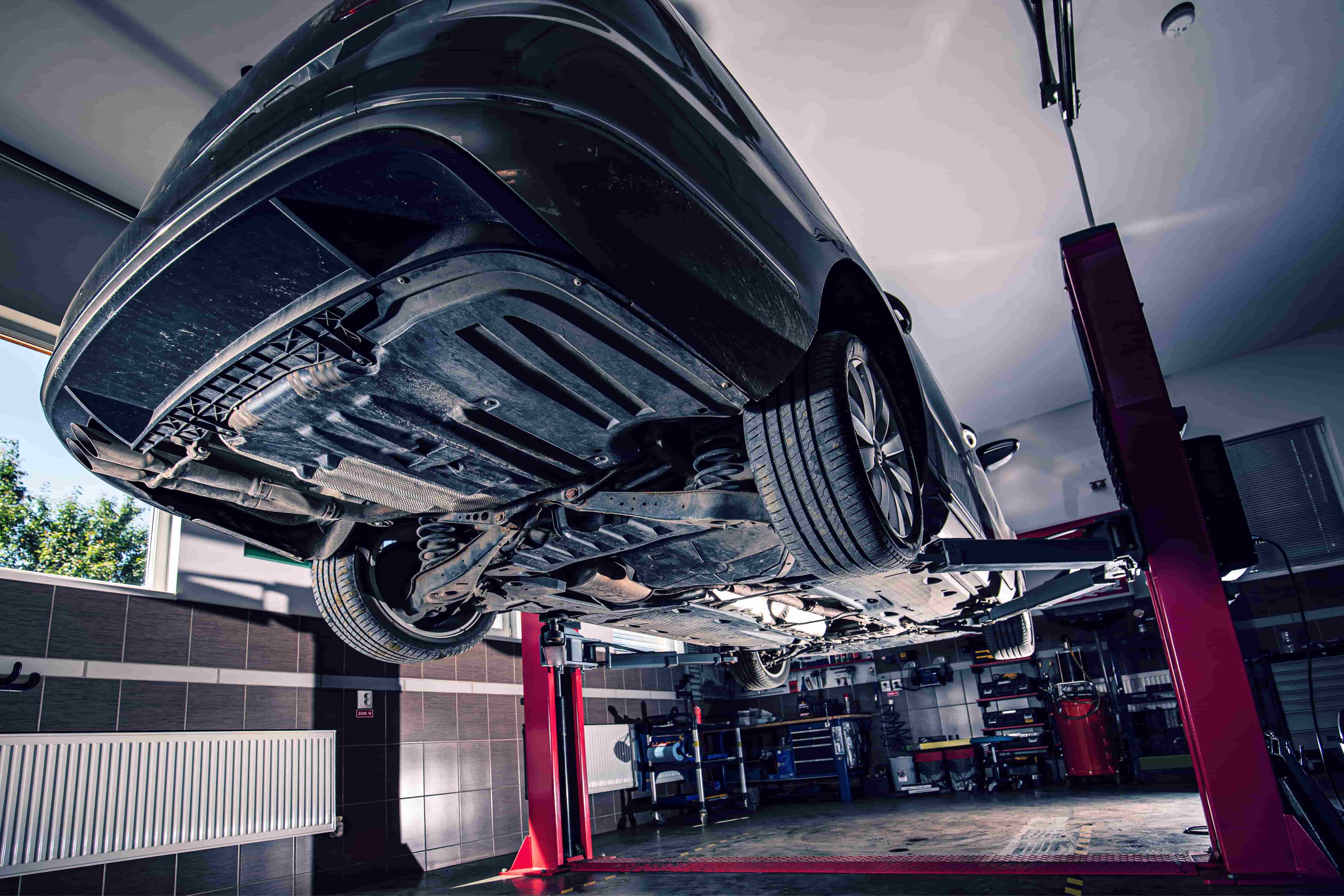 Car Servicing & Repairs in Meadow Heights Professional SUV exhaust service in Meadow Heights - Modern grey SUV on blue hydraulic lift for comprehensive exhaust system inspection